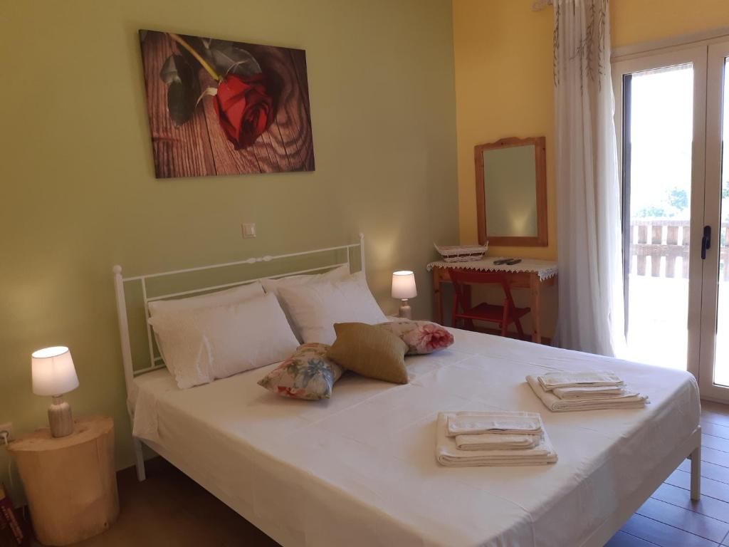 Bedroom of Andri House with a double bed and a door to the balcony